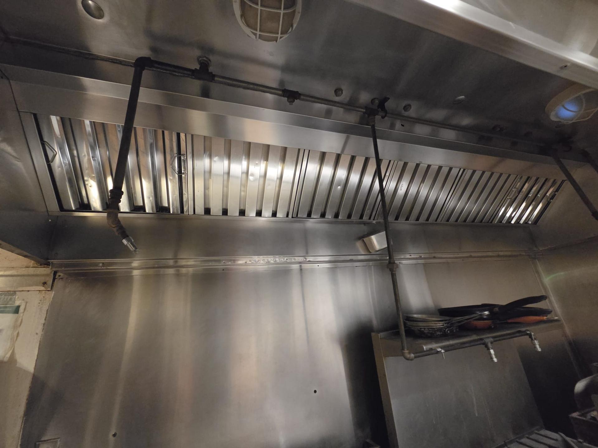 Commercial kitchen hood cleaning service by Northern Hood — grease buildup removed from exhaust hood